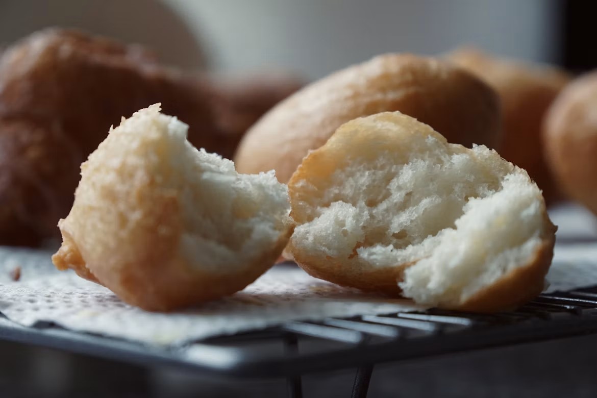 Close-up of a split puff puff showing its soft, fluffy interior